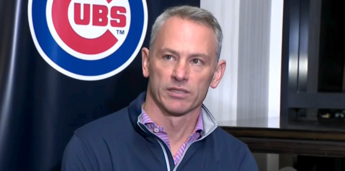 President Jed Hoyer of the Chicago Cubs presents a jersey to