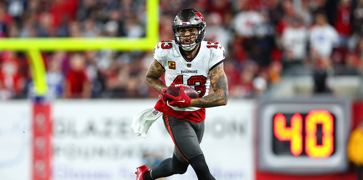 Mike Evans TAMPA, FLORIDA - JANUARY 16: Mike Evans #13 of the Tampa Bay Buccaneers carries the ball against the Dallas Cowboys during the third quarter in the NFC Wild Card playoff game at Raymond James Stadium on January 16, 2023 in Tampa, Florida.