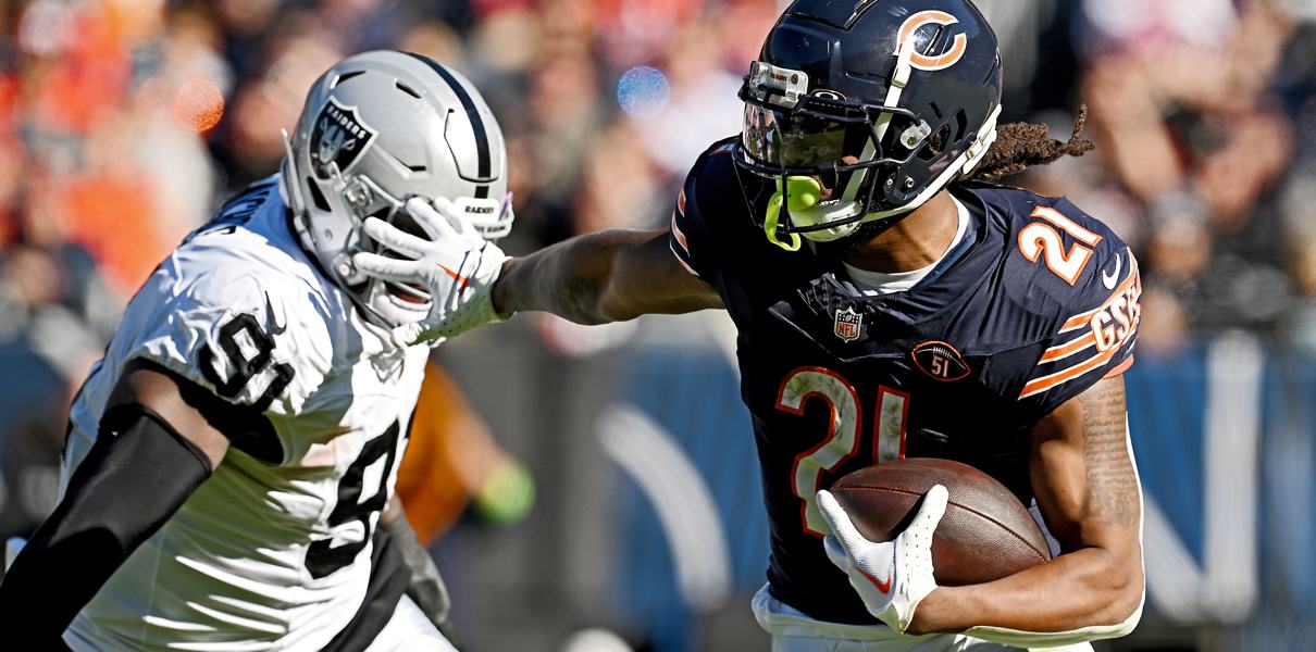 bears rb d'onta foreman stiff arms a defender against the raiders