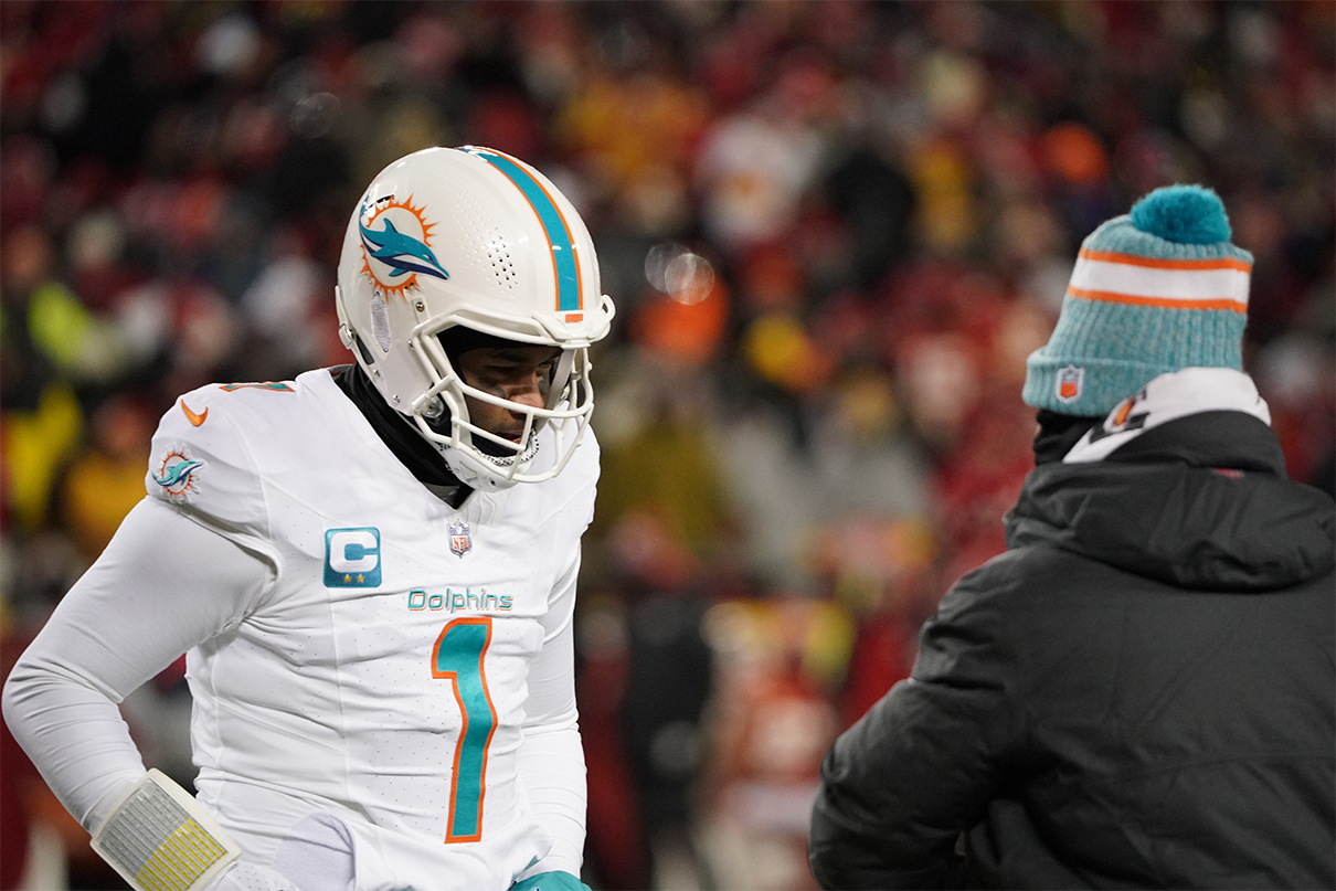 Jan 13, 2024; Kansas City, Missouri, USA; Miami Dolphins quarterback Tua Tagovailoa (1) speaks with head coach Mike McDaniel during the first half of the 2024 AFC wild card game at GEHA Field at Arrowhead Stadium. Mandatory Credit: Denny Medley-USA TODAY Sports