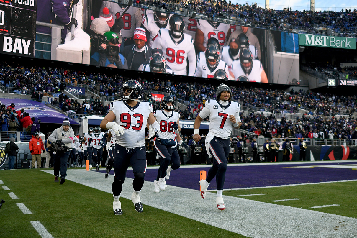 Jan 20, 2024; Baltimore, MD, USA; Houston Texans defensive tackle Kurt Hinish (93) and quarterback C.J. Stroud (7) lead their teammates on to the field before a 2024 AFC divisional round game against the Baltimore Ravens at M&T Bank Stadium. Mandatory Credit: Tommy Gilligan-USA TODAY Sports